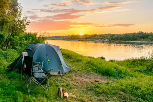 An illustrated campsite scene featuring a tent, campfire, backpack, hammock, and various camping gear. Surrounding icons depict '50 Camping Hacks,' including cooking tricks, DIY tools, waterproofing tips,